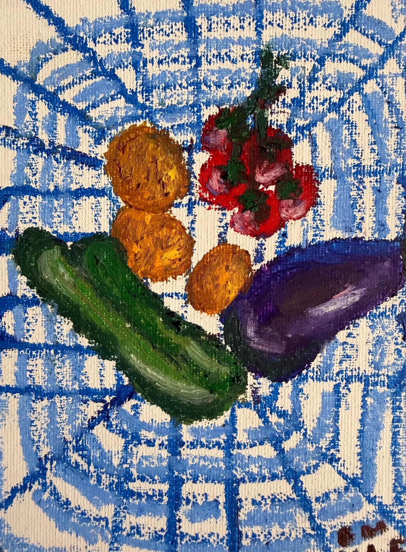 Courgette, aubergine, lemons and red radishes on a blue patterned cloth