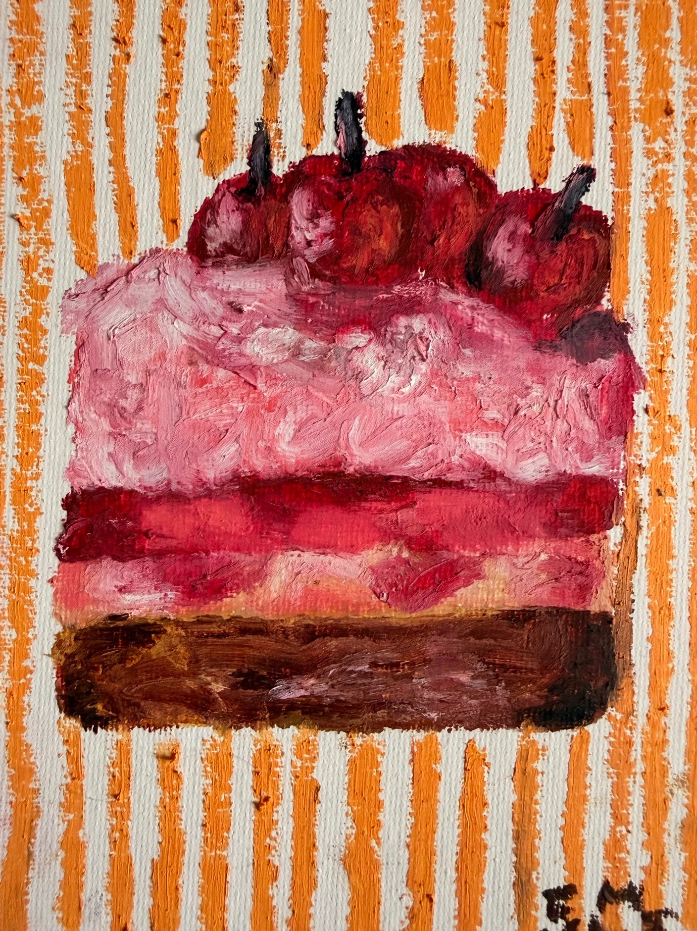 Red slice of cake against an orange striped background