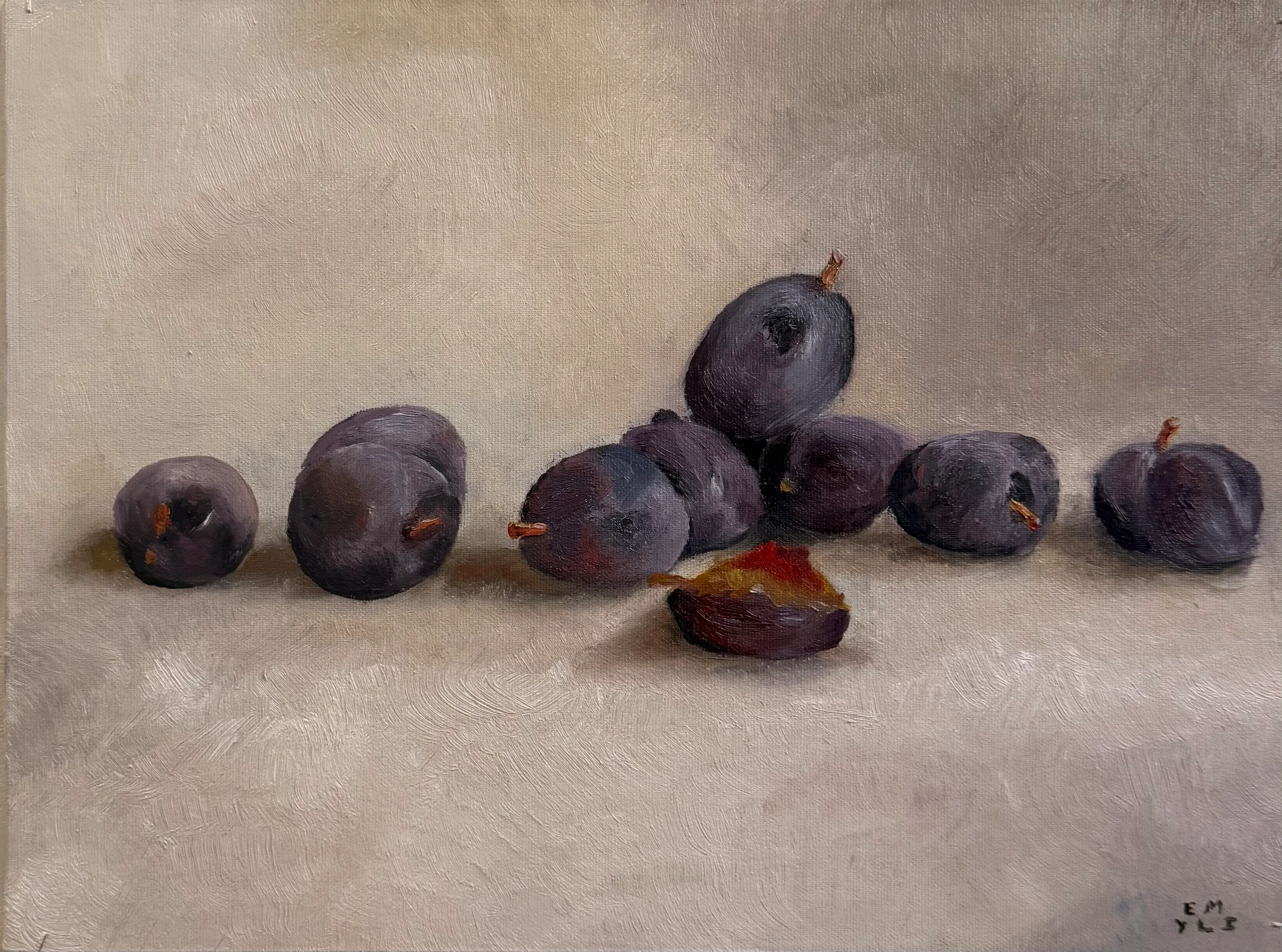 Oil pastel still life of dark plums with one cut open revealing its reddish interior